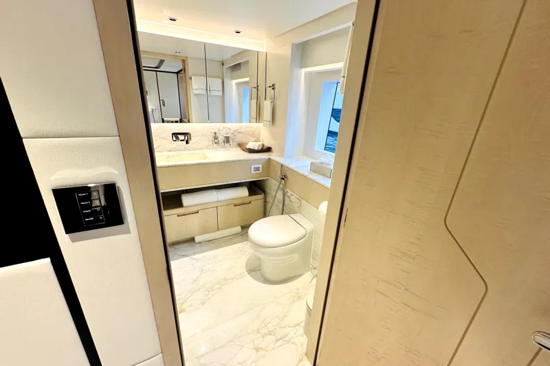 Optimism Yacht Photos Pics Luxurious bathroom interior on 2023 Majesty 120 yacht, featuring marble flooring and modern fixtures.