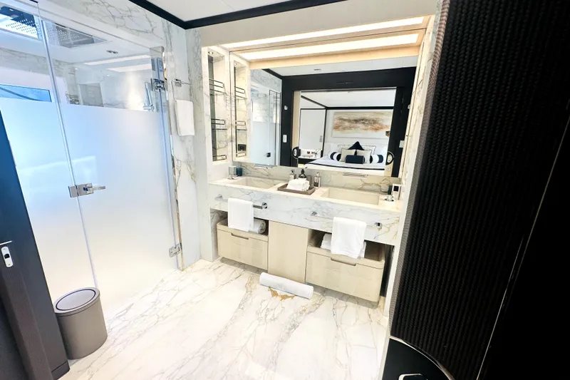 Optimism Yacht Photos Pics Luxurious marble bathroom in 2023 Majesty 120 yacht, featuring modern fixtures and elegant design.