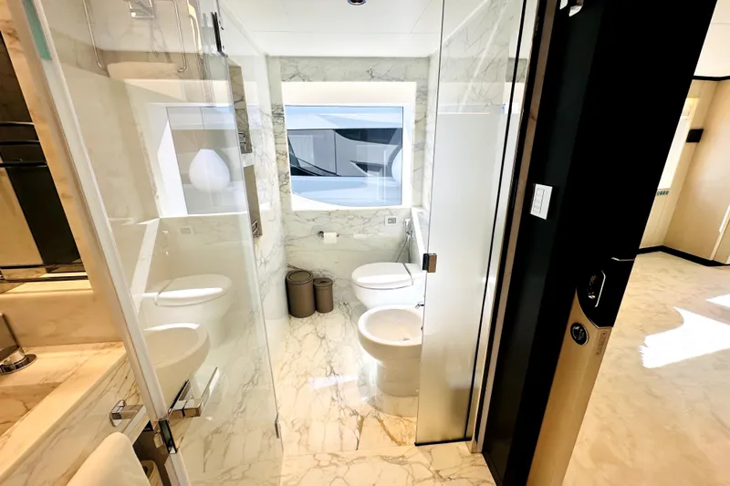 Optimism Yacht Photos Pics Luxurious marble bathroom interior on a 2023 Majesty 120 yacht.