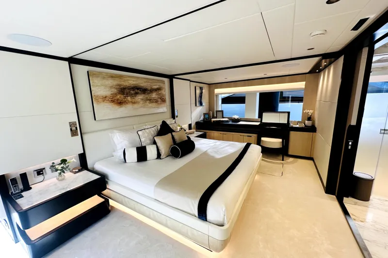 Optimism Yacht Photos Pics Luxurious bedroom interior of 2023 Majesty 120 yacht, featuring modern design and elegant decor.