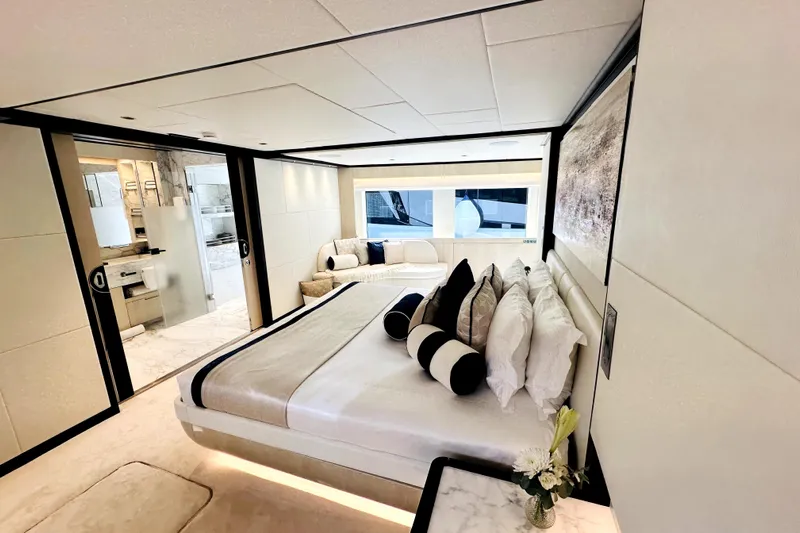 Optimism Yacht Photos Pics Luxurious bedroom interior of 2023 Majesty 120 yacht with modern design and elegant decor.