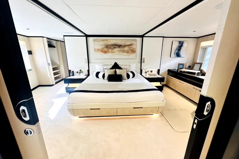 Optimism Yacht Photos Pics Luxurious bedroom interior on 2023 Majesty 120 yacht, featuring modern design and elegant decor.