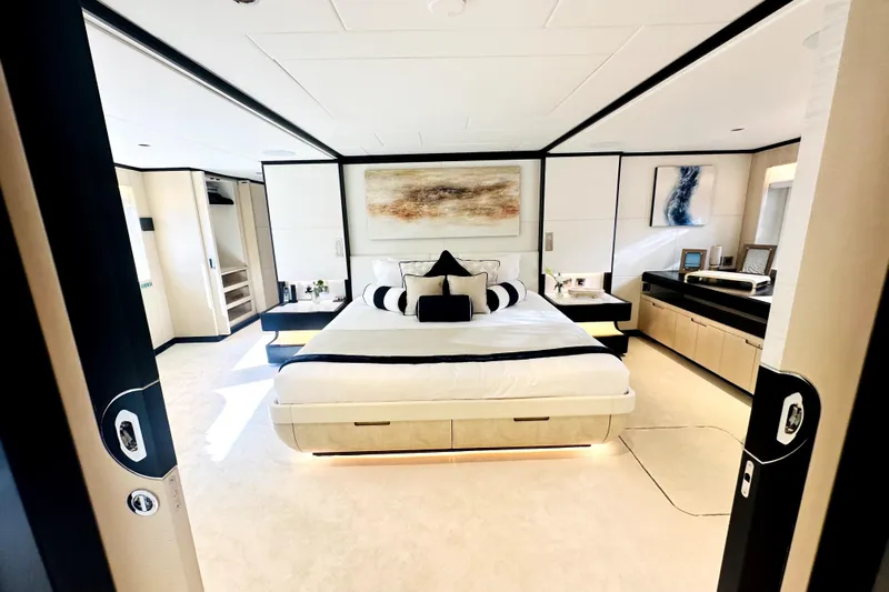 Optimism Yacht Photos Pics Luxurious 2023 Majesty 120 yacht bedroom with modern decor and elegant furnishings.
