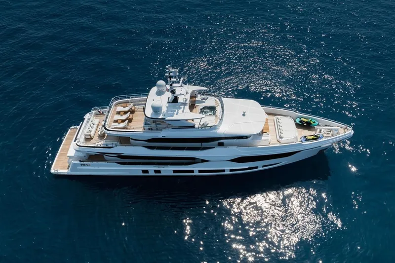 Optimism Yacht Photos Pics Luxurious 2023 Majesty 120 yacht cruising on open blue sea.
