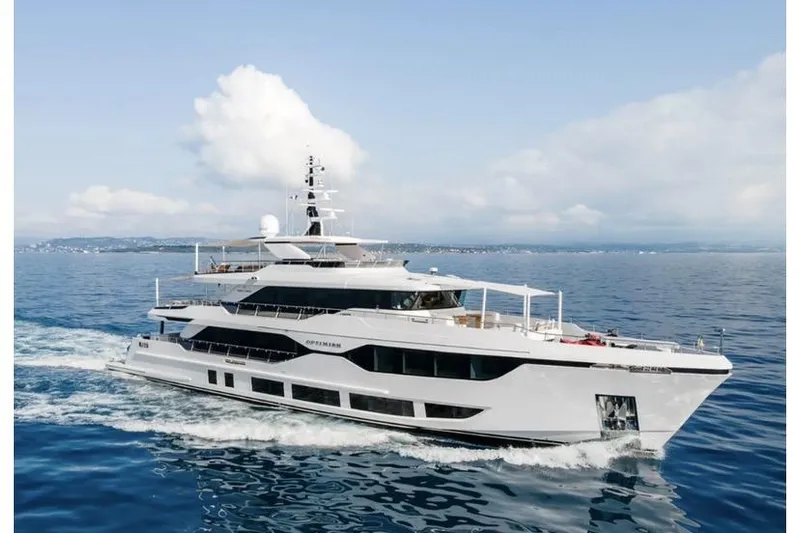 Optimism Yacht Photos Pics Luxurious 2023 Majesty 120 yacht cruising on open sea under clear skies.