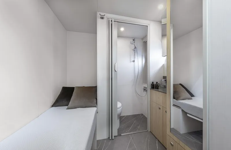 Absolute Navetta 64 Yacht Photos Pics 2025 Absolute Navetta 64 yacht interior with compact bathroom and cozy sleeping area.