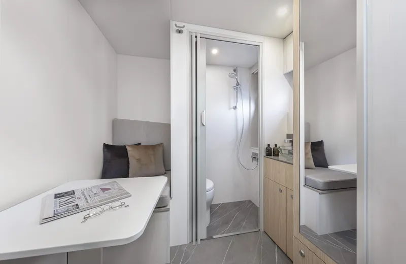 Absolute Navetta 64 Yacht Photos Pics Luxurious interior of 2025 Absolute Navetta 64 yacht with modern bathroom and seating area.