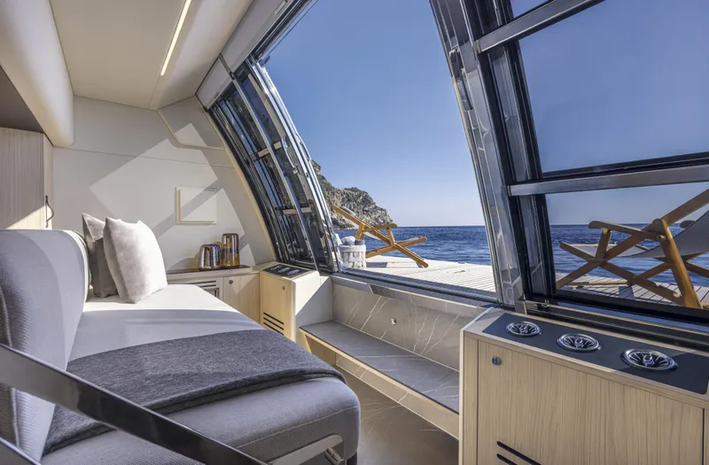 Absolute Navetta 64 Yacht Photos Pics Luxurious interior of 2025 Absolute Navetta 64 yacht with ocean view through large windows.