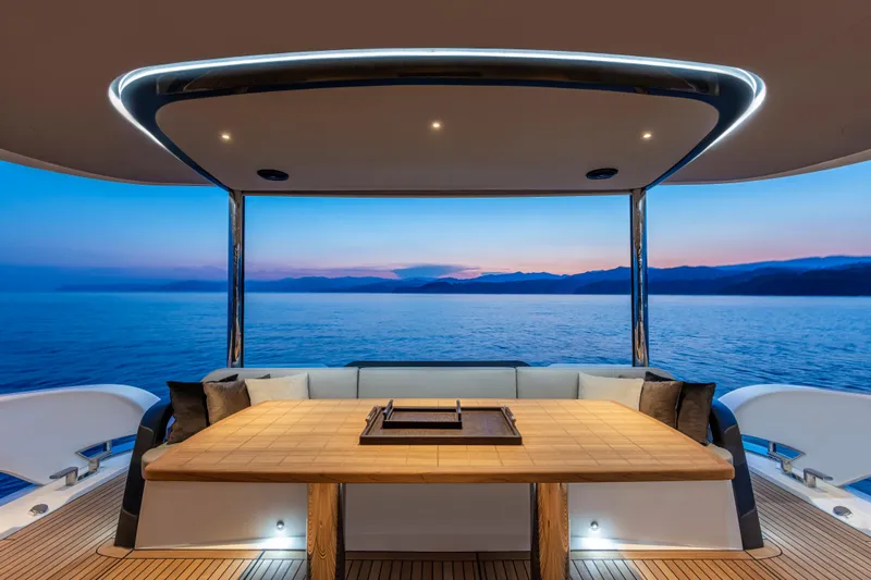 Absolute Navetta 64 Yacht Photos Pics Luxurious 2025 Absolute Navetta 64 yacht deck with ocean view at sunset.