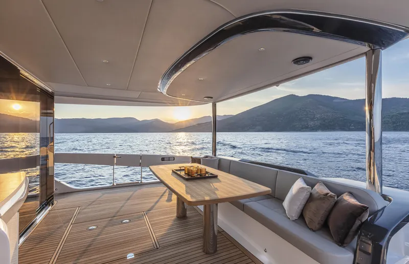 Absolute Navetta 64 Yacht Photos Pics Luxurious 2025 Absolute Navetta 64 yacht deck with sunset view over the ocean.