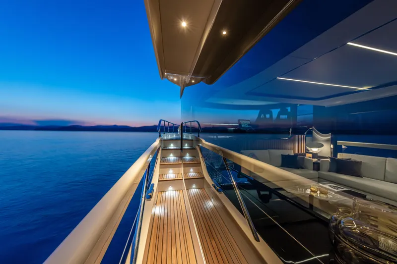 Absolute Navetta 64 Yacht Photos Pics Luxurious Absolute Navetta 64 yacht deck at sunset, 2025 model, with serene ocean view.