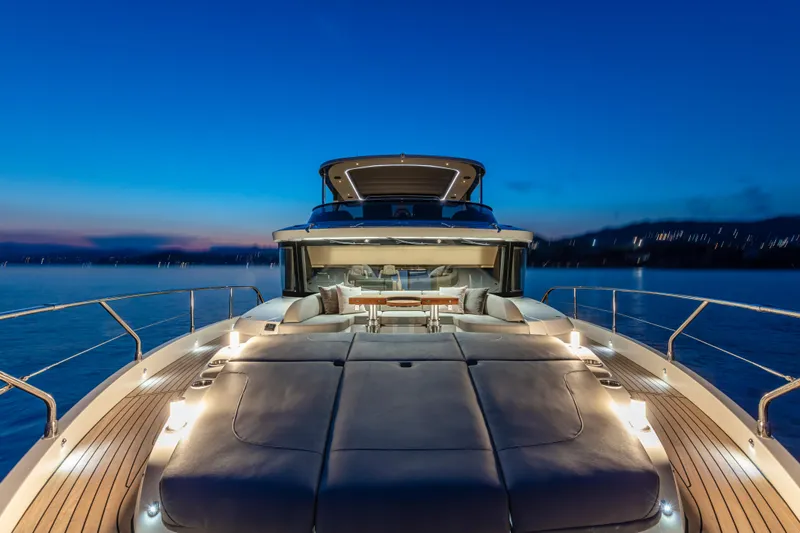 Absolute Navetta 64 Yacht Photos Pics Luxurious 2025 Absolute Navetta 64 yacht at sunset, featuring elegant deck lighting.