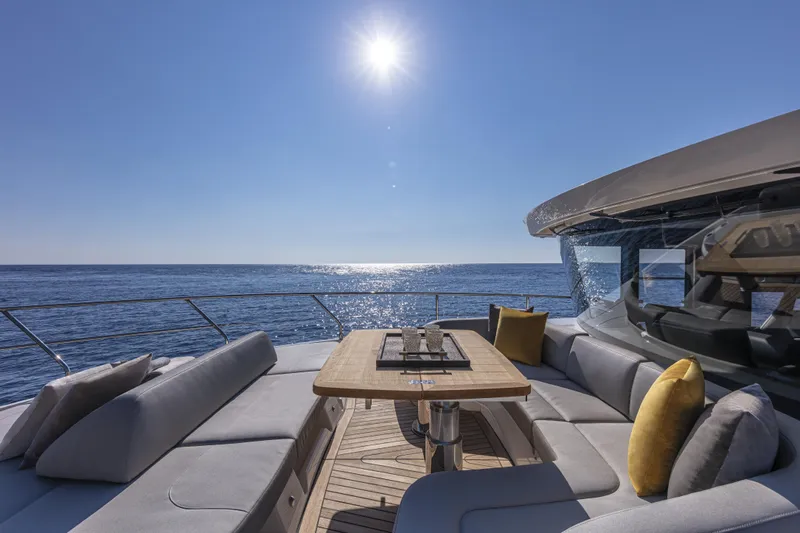 Absolute Navetta 64 Yacht Photos Pics Luxurious 2025 Absolute Navetta 64 yacht deck with ocean view and sunlit seating area.