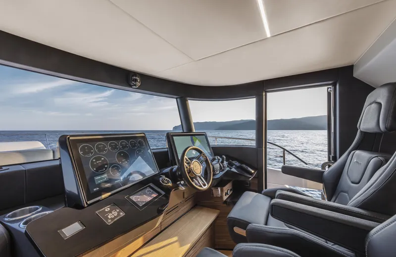 Absolute Navetta 64 Yacht Photos Pics Luxurious helm of 2025 Absolute Navetta 64 yacht with modern controls and ocean view.