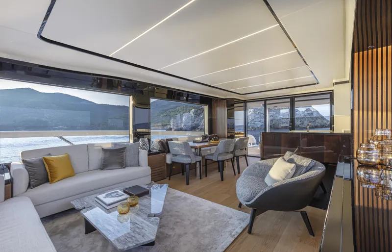 Absolute Navetta 64 Yacht Photos Pics Luxurious interior of 2025 Absolute Navetta 64 yacht with panoramic windows and elegant furnishings.