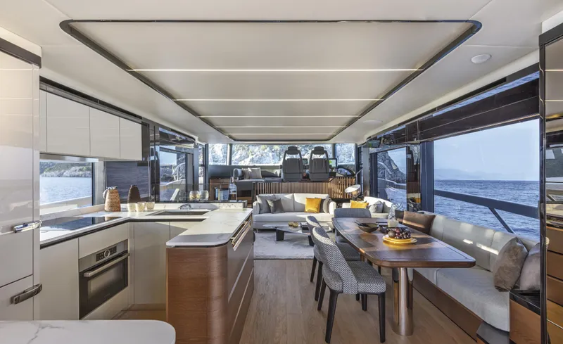 Absolute Navetta 64 Yacht Photos Pics Luxurious interior of 2025 Absolute Navetta 64 yacht with modern kitchen and dining area.