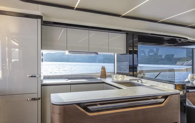Absolute Navetta 64 Yacht Photos Pics Luxurious kitchen interior of 2025 Absolute Navetta 64 yacht with ocean view.