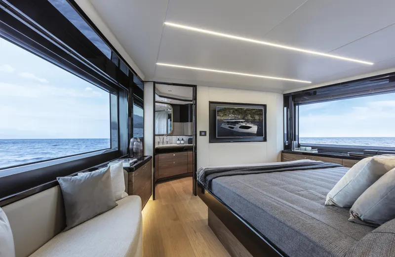 Absolute Navetta 64 Yacht Photos Pics Luxurious bedroom interior of 2025 Absolute Navetta 64 yacht with ocean view.