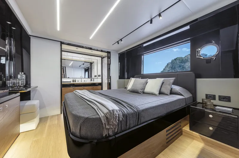Absolute Navetta 64 Yacht Photos Pics Luxurious bedroom interior of 2025 Absolute Navetta 64 yacht with modern design and scenic window view.