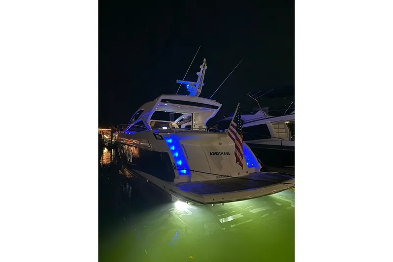  Yacht Photos Pics 2017 Sunseeker Predator 57 yacht illuminated at night with blue lights.