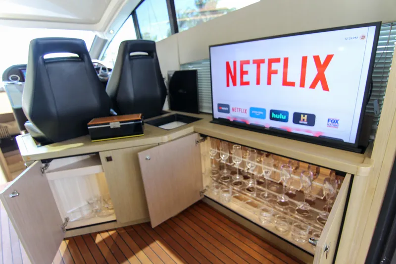  Yacht Photos Pics Luxurious Sunseeker Predator 57 yacht interior with TV and glassware cabinet, 2017 model.