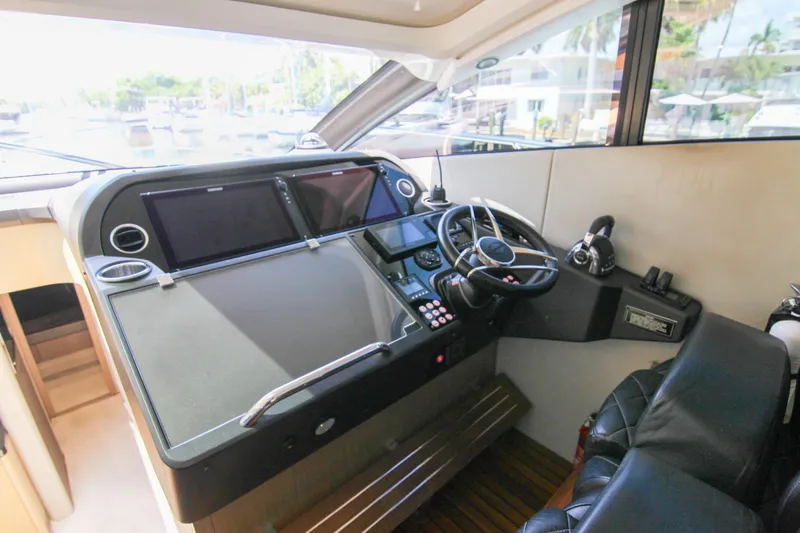  Yacht Photos Pics Helm of 2017 Sunseeker Predator 57 yacht with modern controls and navigation screens.