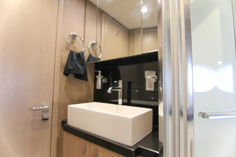  Yacht Photos Pics Luxurious bathroom interior of 2017 Sunseeker Predator 57 yacht, featuring modern sink and fixtures.