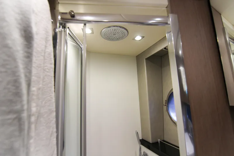  Yacht Photos Pics Interior of 2017 Sunseeker Predator 57 yacht bathroom with modern shower and porthole.