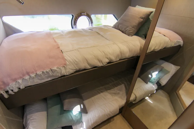  Yacht Photos Pics Bunk beds in 2017 Sunseeker Predator 57 yacht cabin, featuring cozy bedding and modern design.