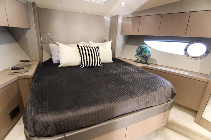  Yacht Photos Pics Luxurious bedroom interior of 2017 Sunseeker Predator 57 yacht with modern design elements.