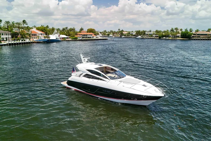  Yacht Photos Pics 2017 Sunseeker Predator 57 yacht cruising on a scenic waterfront.