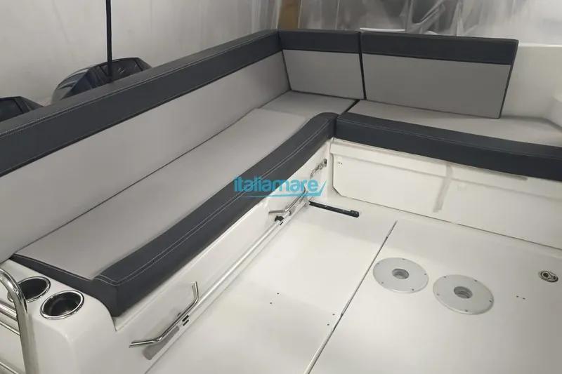  Yacht Photos Pics 2019 Jeanneau Merry Fisher 895 interior seating with gray cushions and cup holders.