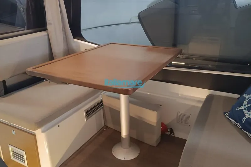  Yacht Photos Pics Interior of 2019 Jeanneau Merry Fisher 895 with wooden table and seating area.
