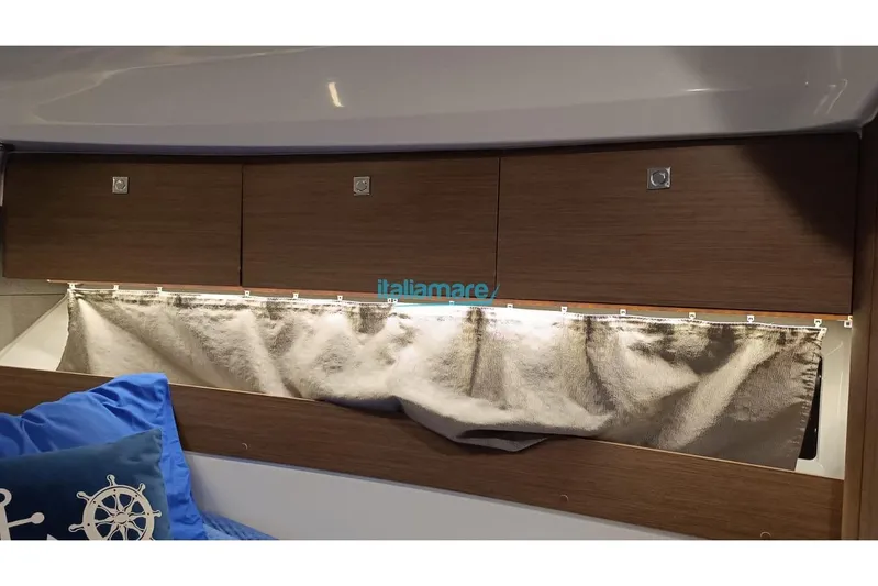  Yacht Photos Pics Interior of 2019 Jeanneau Merry Fisher 895 with wooden cabinets and curtains.