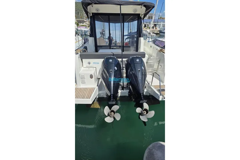  Yacht Photos Pics 2019 Jeanneau Merry Fisher 895 with dual outboard motors docked in marina.