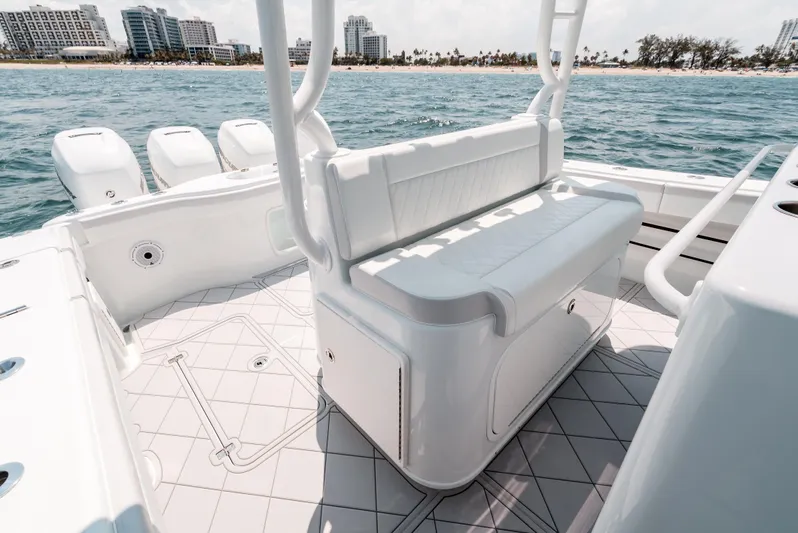  Yacht Photos Pics 2017 Yellowfin 42 boat interior with seating, ocean view, and city skyline in the background.