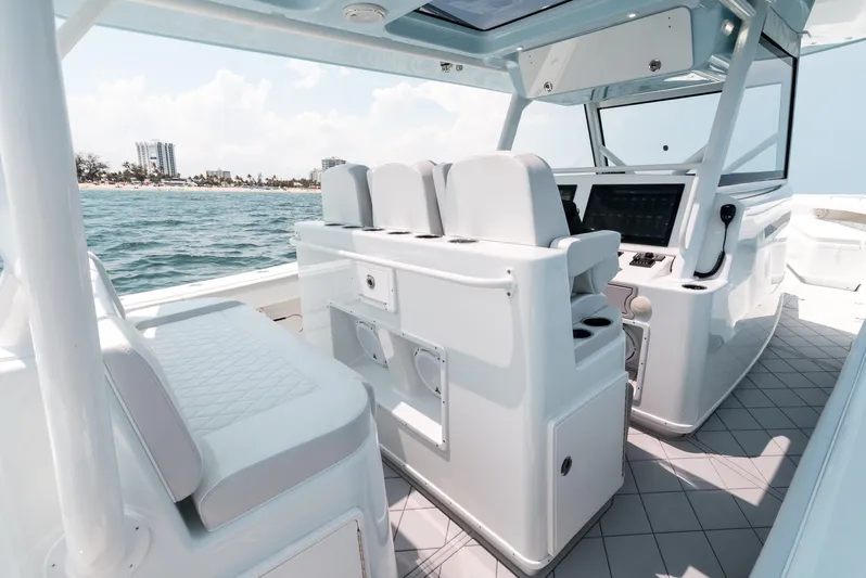  Yacht Photos Pics 2017 Yellowfin 42 boat interior with modern seating and control panel, cruising on open water.