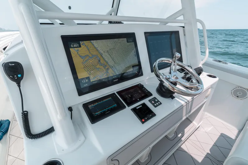  Yacht Photos Pics 2017 Yellowfin 42 boat dashboard with navigation screens and steering wheel.