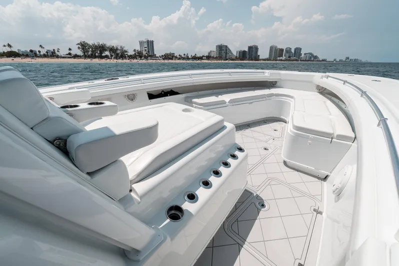  Yacht Photos Pics 2017 Yellowfin 42 boat interior with white seating, ocean view, and city skyline in background.