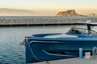 2024 Solaris Power 60 Open yacht docked at sunset with scenic coastal backdrop.