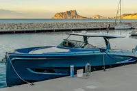 2024 Solaris Power 60 Open yacht docked in a serene marina at sunset.