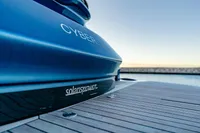 2024 Solaris Power 60 Open yacht docked, showcasing sleek blue design and branding.