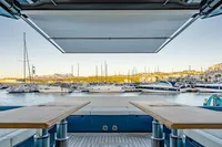 2024 Solaris Power 60 Open yacht interior with marina view, featuring elegant wooden tables.