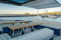 Luxurious 2024 Solaris Power 60 Open yacht with spacious outdoor seating and scenic marina view.