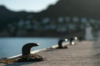 Close-up of dock cleat with blurred marina background, Solaris Power 60 Open, 2024.