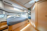 Luxurious cabin interior of 2024 Solaris Power 60 Open yacht, featuring a cozy bed and modern design.