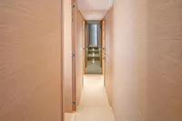 Narrow hallway inside 2024 Solaris Power 60 Open yacht, featuring sleek wooden paneling.