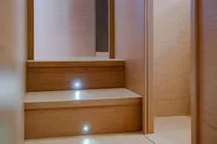 Wooden stairs with LED lights on a 2024 Solaris Power 60 Open yacht.