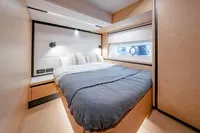Luxurious cabin interior of 2024 Solaris Power 60 Open yacht, featuring a cozy bed and modern design.
