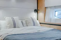 Luxurious bedroom interior of 2024 Solaris Power 60 Open yacht, featuring elegant bedding and modern design.